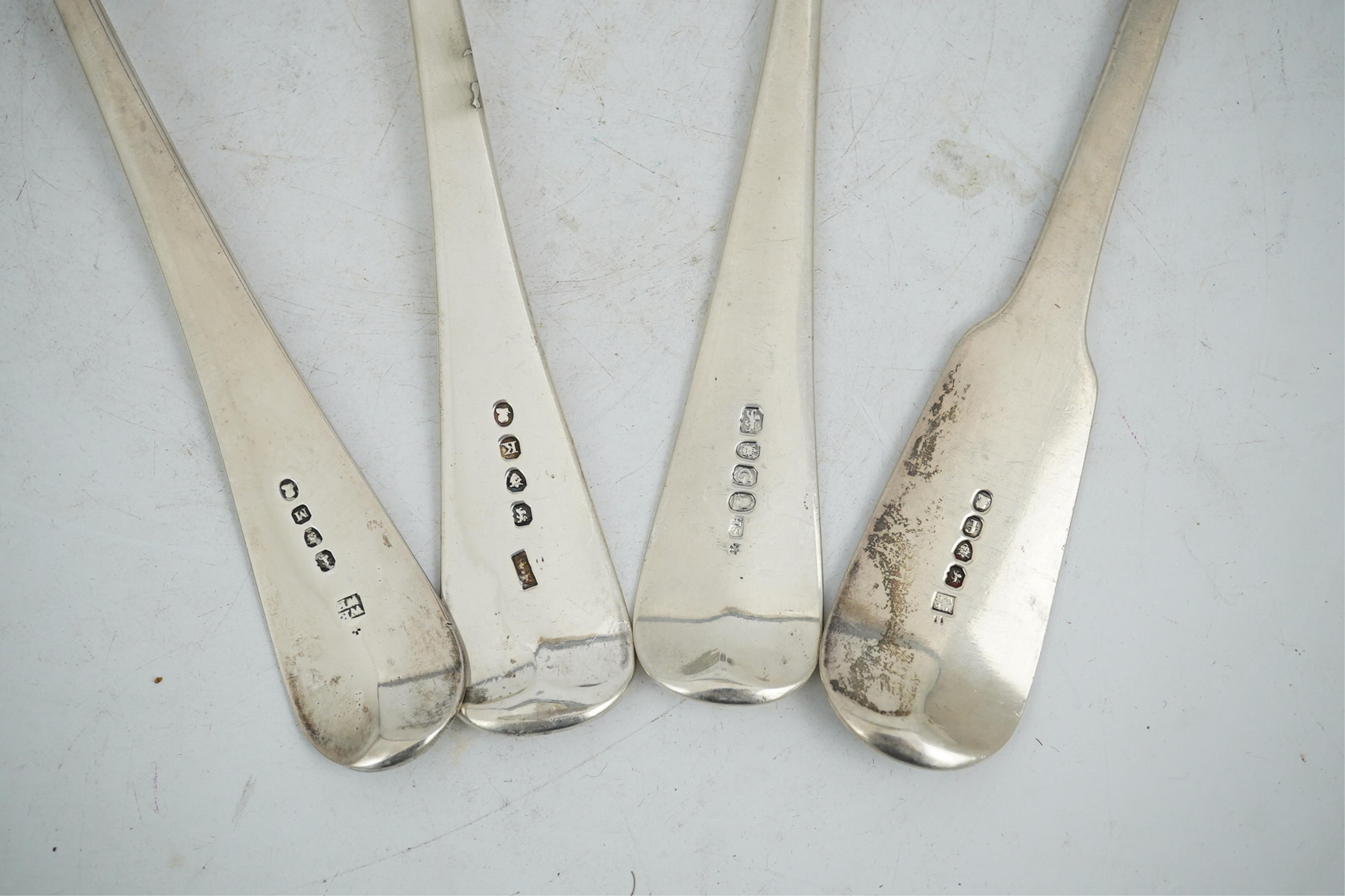 Three George III silver Old English pattern soup ladles, London, 1802, 1805 and 1808, various makers, together with a George IV silver fiddle pattern soup ladle by Eley & Fearn, London, 1821, 23oz.